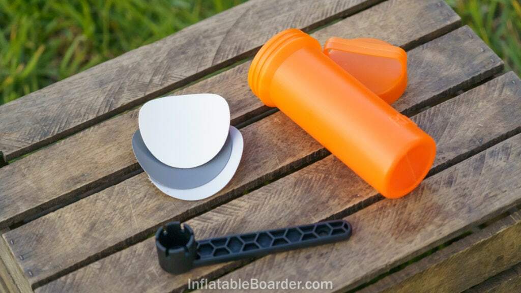 The NIXY repair kit includes three vinyl patches, a valve wrench, and an orange container.