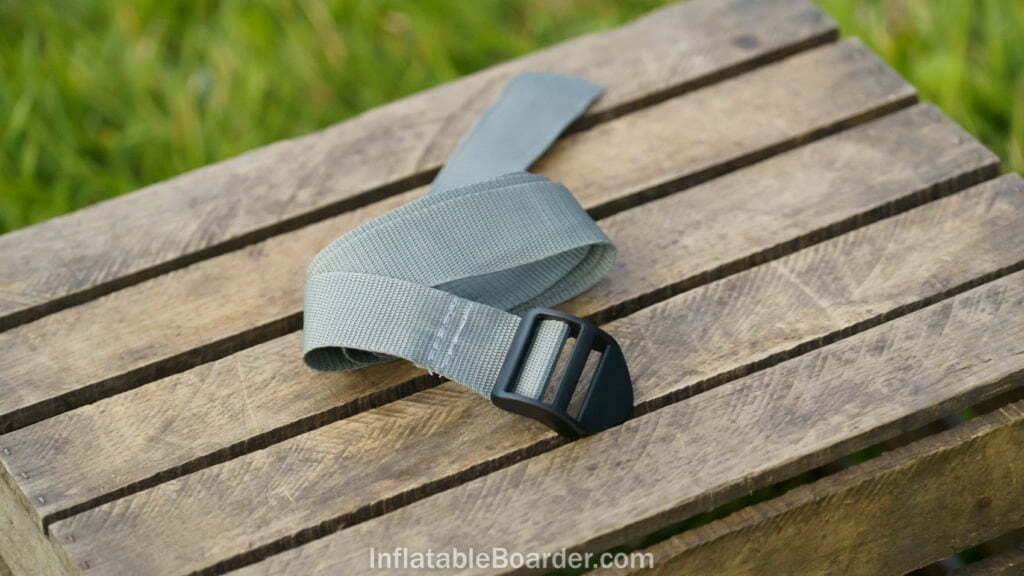 The included SUP compression strap is made of woven gray nylon.