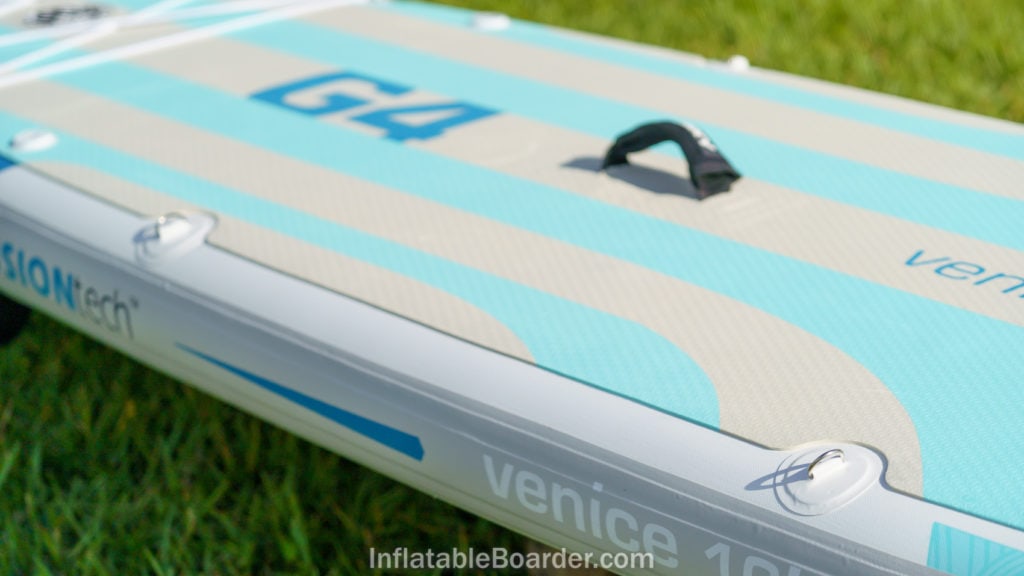 The side of the SUP features two sets of d-rings, a cushioned handle, and large foam pad.