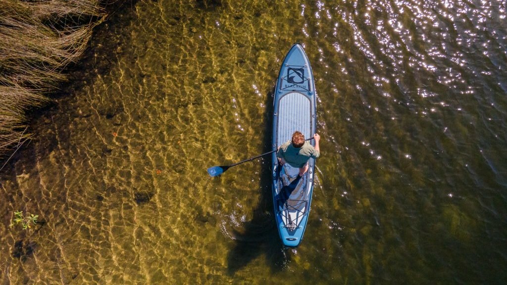 Top view of paddling the Model V on a river.