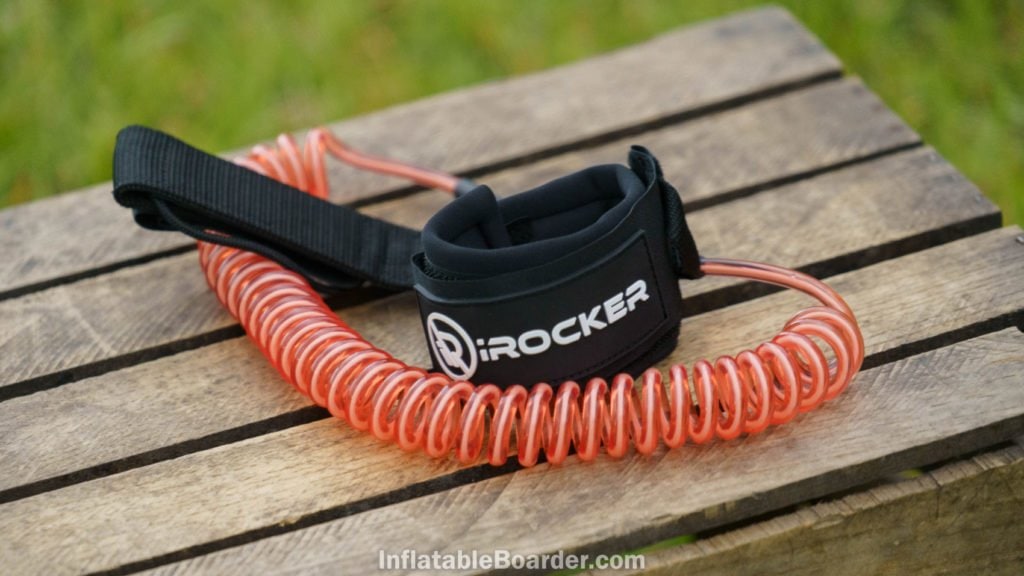 The coral-pink coiled SUP leash.