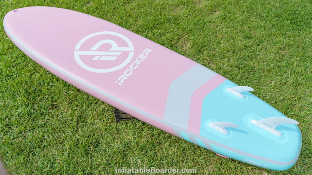 Bottom of the pink All-Around 10' with fins, front d-ring, and large iROCKER logo.