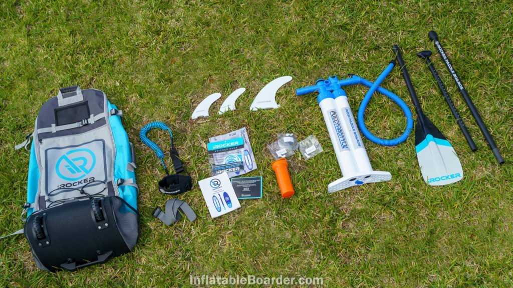 2021 iROCKER blue SUP accessories overview, featuring color-matched bag, color-matched paddle, color-matched leash, premium pump, 3 fins, repair kit, and sticker pack.