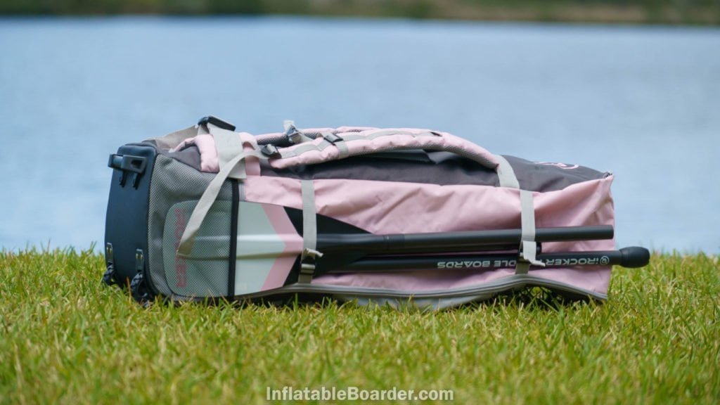 Side of the pink bag with paddle pocket and two straps.