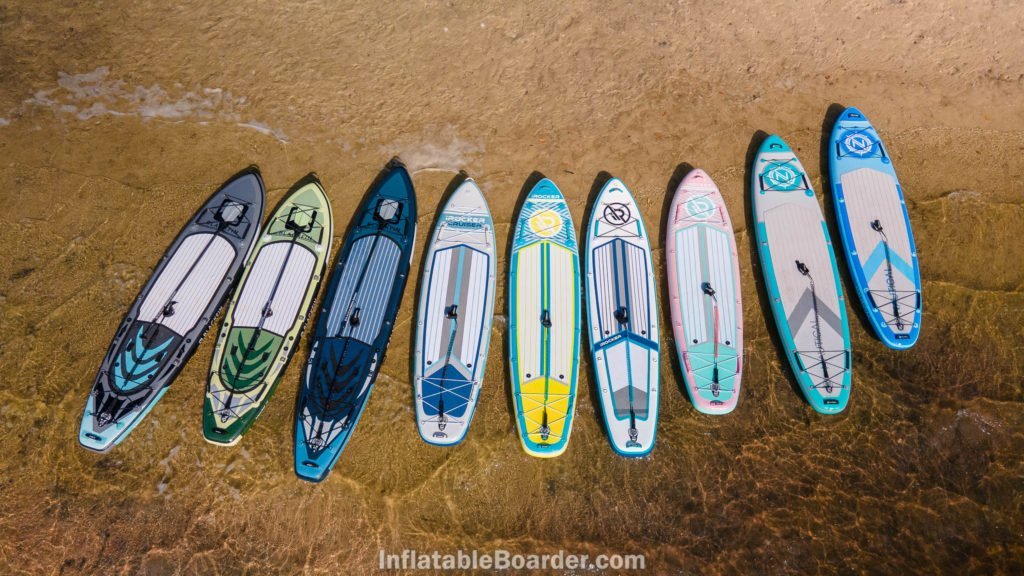 2021 iROCKER, NAUTICAL, and BLACKFIN range of boards on a beach..