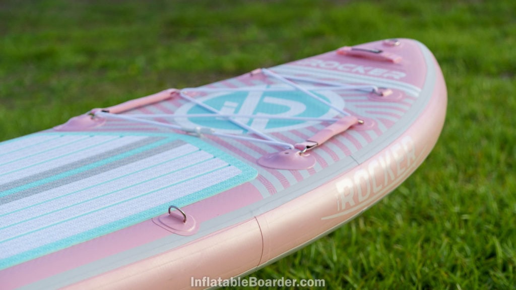 Nose of the pink board with iROCKER logos, handle, cargo area, action mounts, and d-ring.