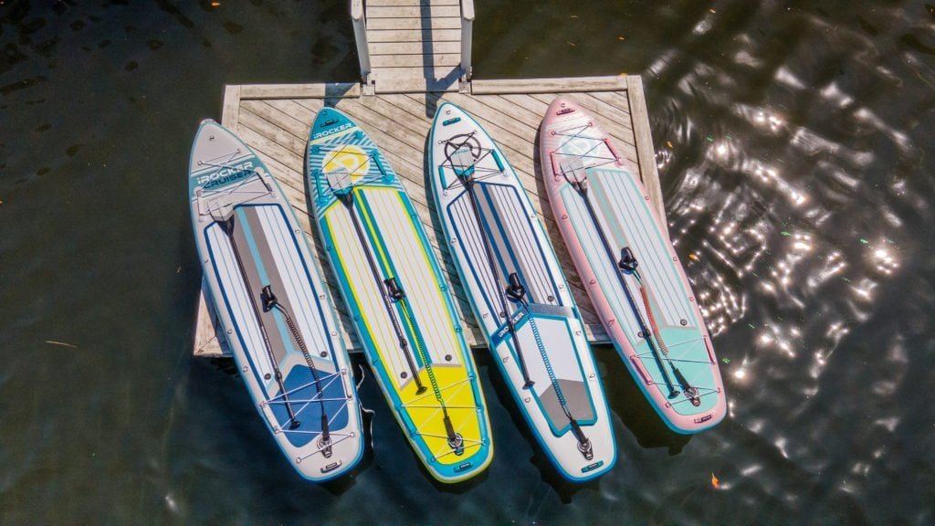 2021 iROCKER paddle boards on a dock. Left to right: Cruiser, All-Around 11', Sport, and All-Around 10'.