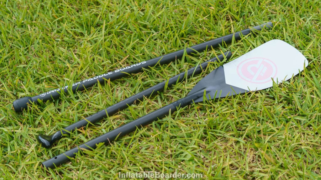 The three-piece pink iROCKER paddle on grass.