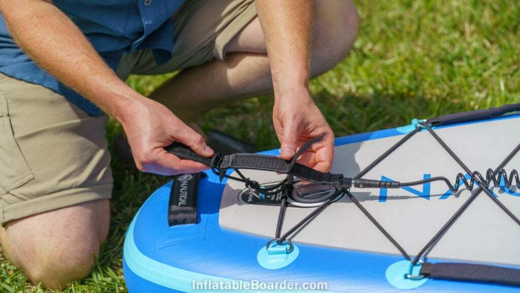 Attaching the SUP leash to the rear d-ring.