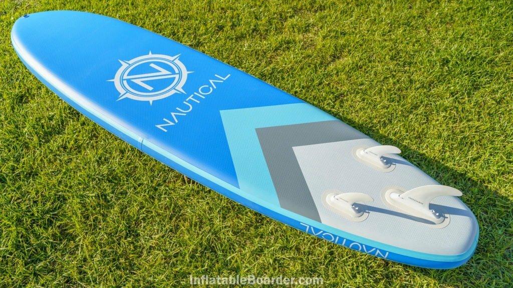 Overview of the bottom fo the 2021 NAUTICAL 10'6" paddle board, featuring three quick-attach fins and large logo.