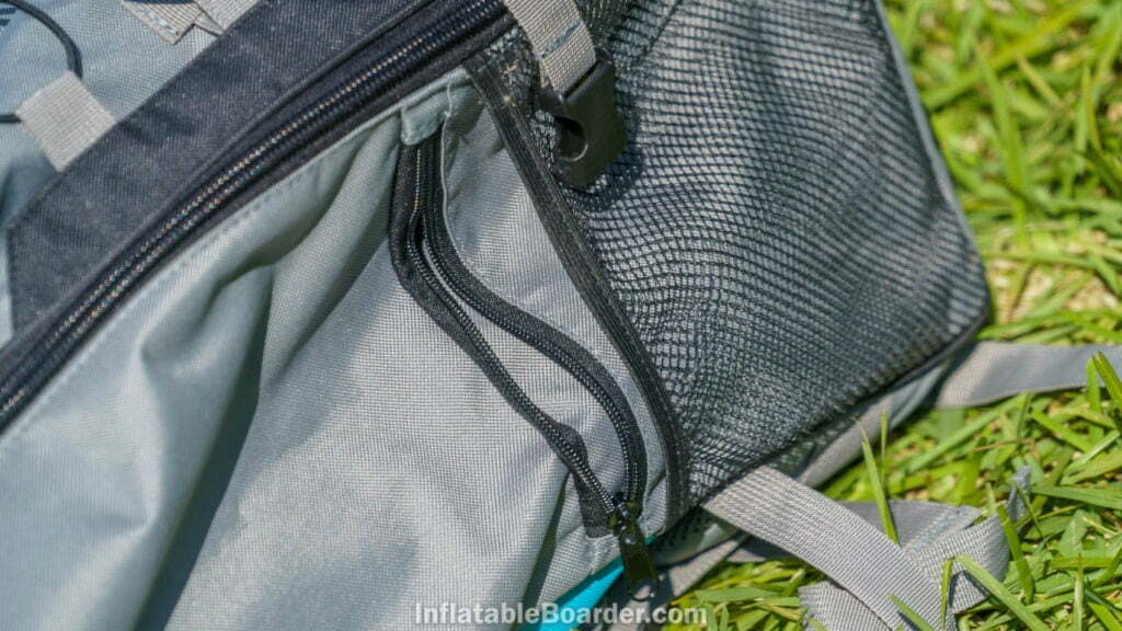 The bag has a small zippered pocket by each side paddle holder.