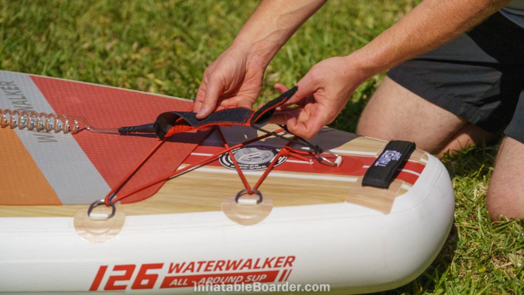 Attaching the velcro SUP leash at the back of the board.