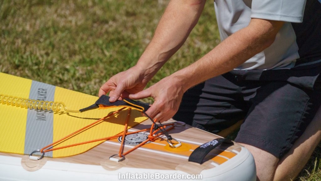 Attaching the color-matched SUP leash.