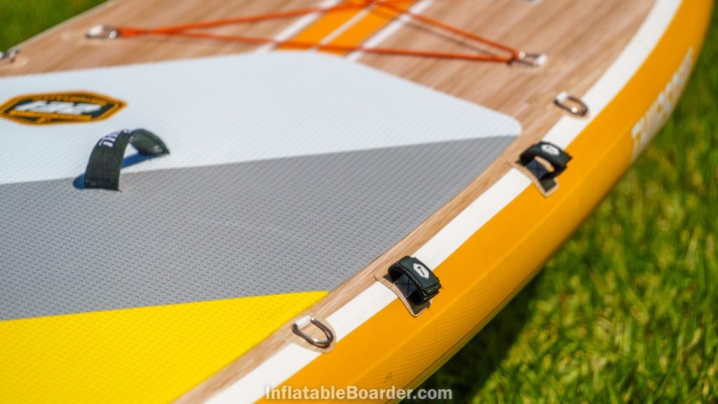 The side of the board has two velcro strips for holding the paddle, as well as two d-rings.