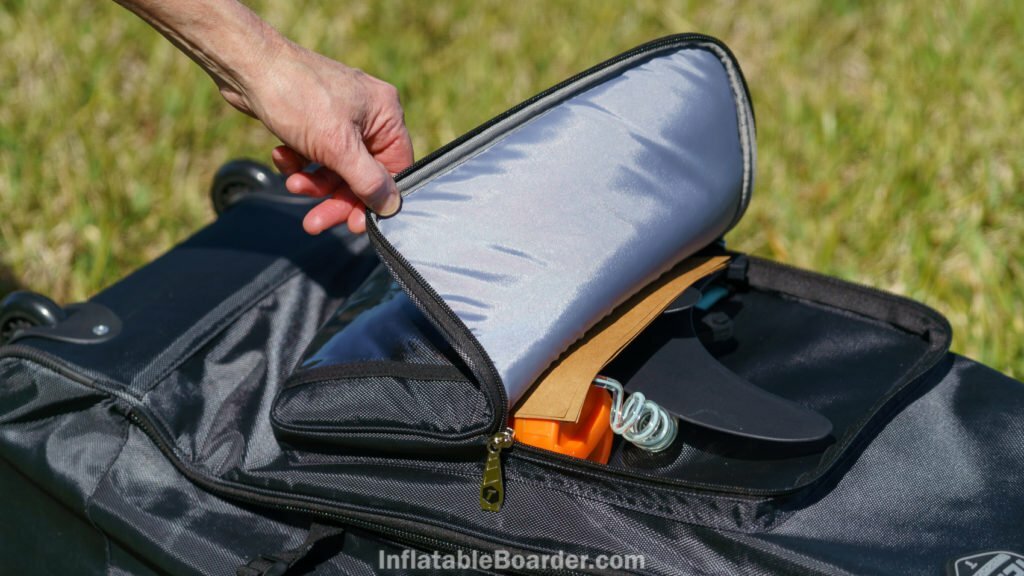 The front pocket is padded and just large enough to carry the fins, leash, and repair kit.